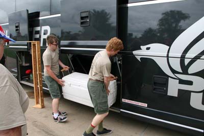 Crew Loading Gear Onto New Bus